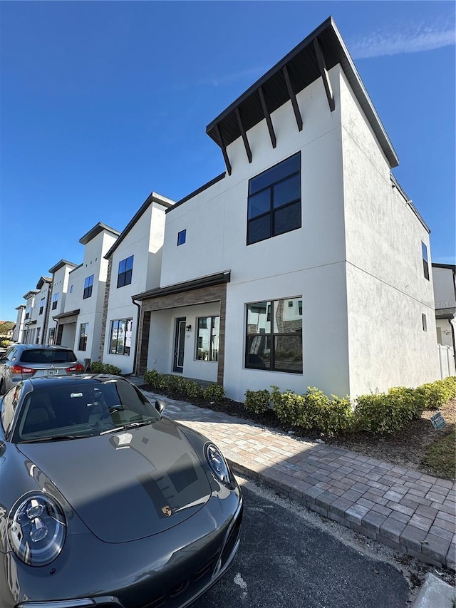 view of front of home featuring a residential view and stucco siding