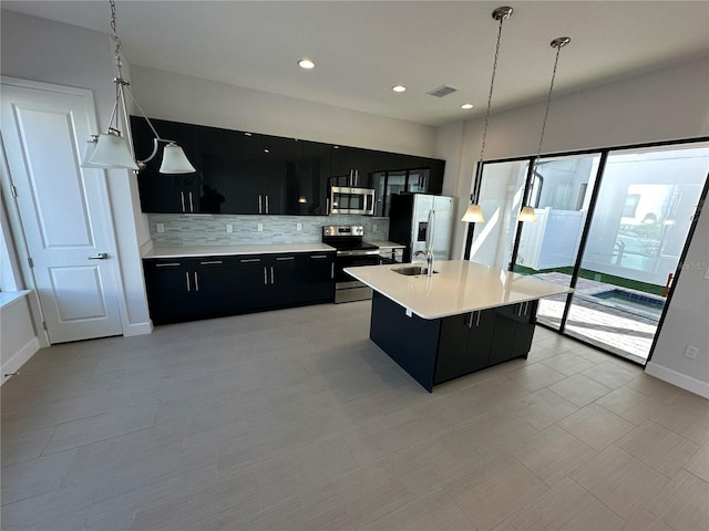 kitchen featuring visible vents, a sink, stainless steel appliances, light countertops, and dark cabinets