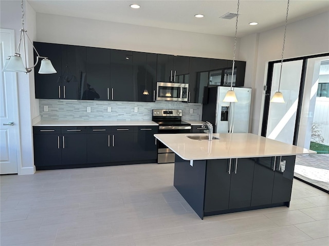 kitchen with visible vents, a sink, stainless steel appliances, light countertops, and dark cabinets