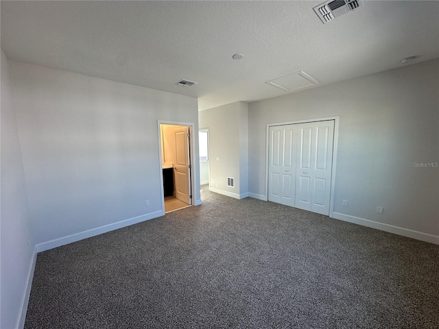 unfurnished bedroom featuring visible vents, carpet floors, a textured ceiling, and baseboards