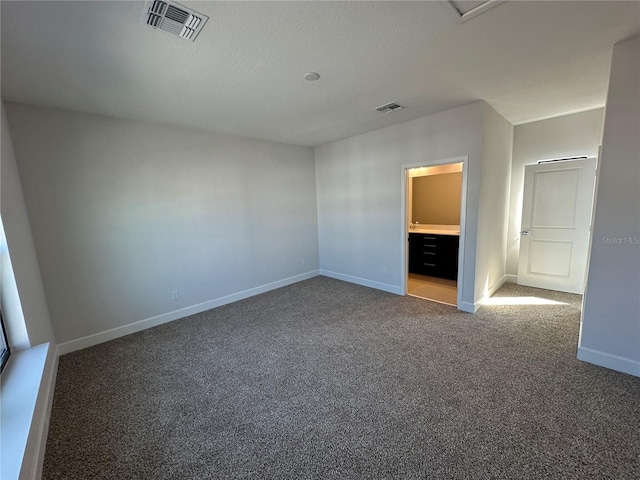 unfurnished bedroom with visible vents, baseboards, and carpet