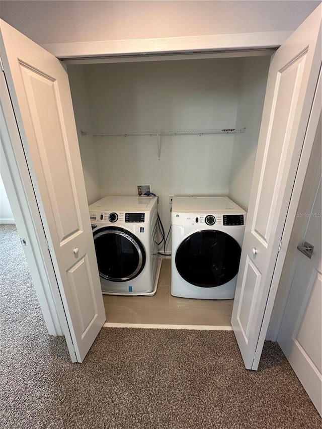 washroom with laundry area, washer and dryer, and carpet flooring