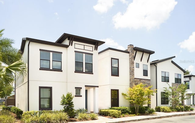 view of front of property with stone siding and stucco siding