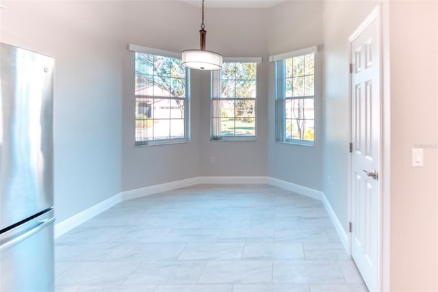 spare room featuring baseboards