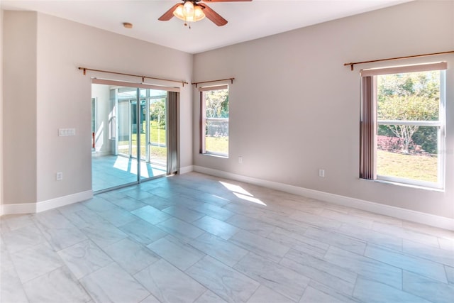 empty room with baseboards and ceiling fan