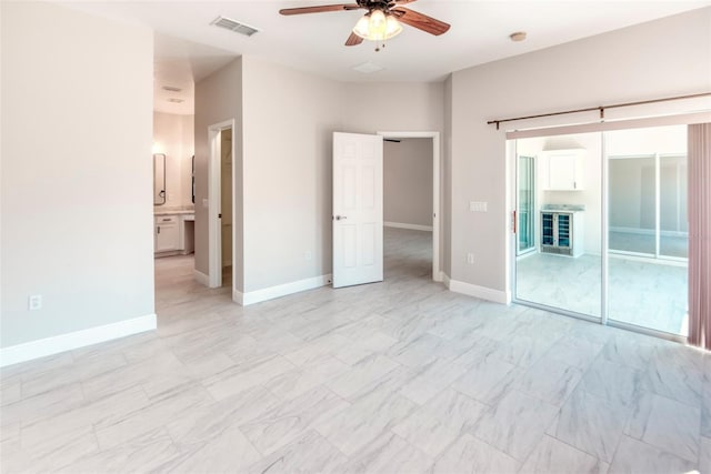 unfurnished bedroom with visible vents, baseboards, ensuite bath, and a ceiling fan