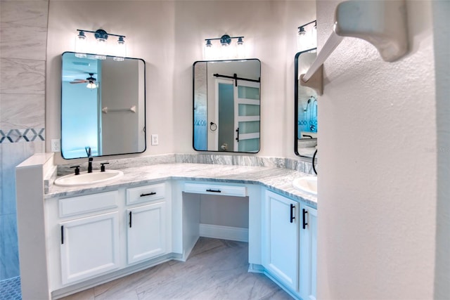 bathroom featuring a sink, marble finish floor, ceiling fan, and double vanity