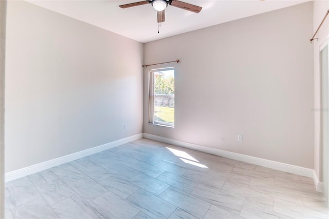 unfurnished room with baseboards and a ceiling fan