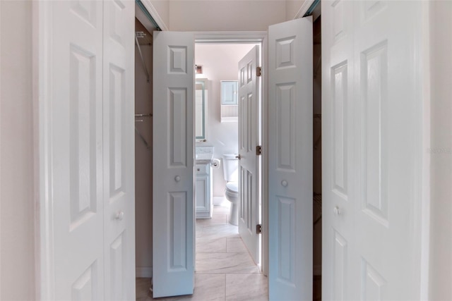 hallway featuring marble finish floor