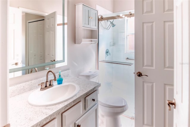 full bath featuring a shower stall, toilet, and vanity