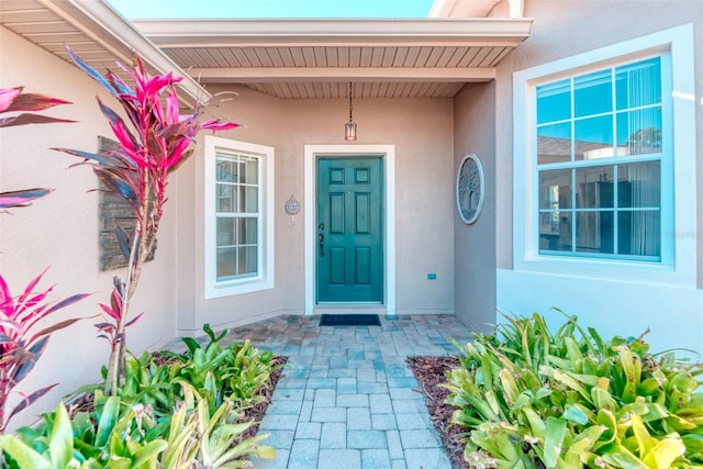 property entrance with stucco siding