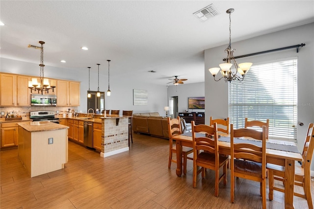 dining area with recessed lighting, visible vents, ceiling fan with notable chandelier, and light wood-type flooring