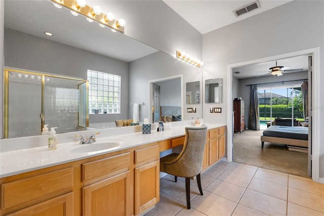 ensuite bathroom featuring visible vents, a stall shower, a sink, tile patterned flooring, and connected bathroom