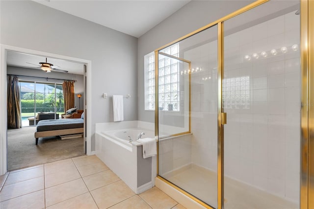 ensuite bathroom with a ceiling fan, a shower stall, ensuite bathroom, a garden tub, and tile patterned floors