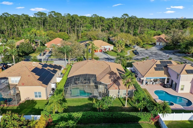 drone / aerial view with a residential view and a wooded view