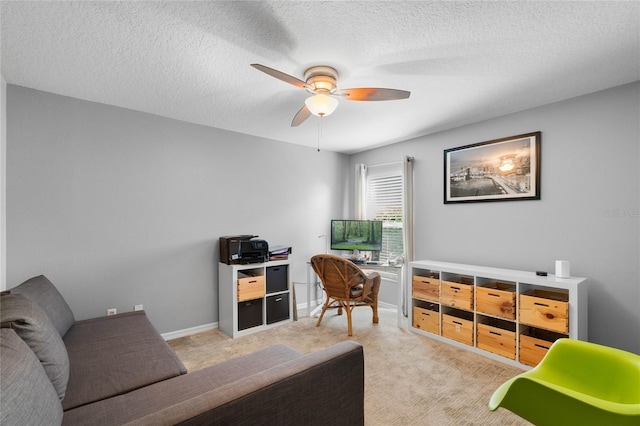 office space with carpet, a ceiling fan, baseboards, and a textured ceiling