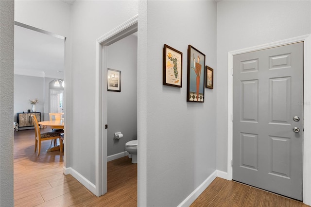 entryway with baseboards and wood finished floors