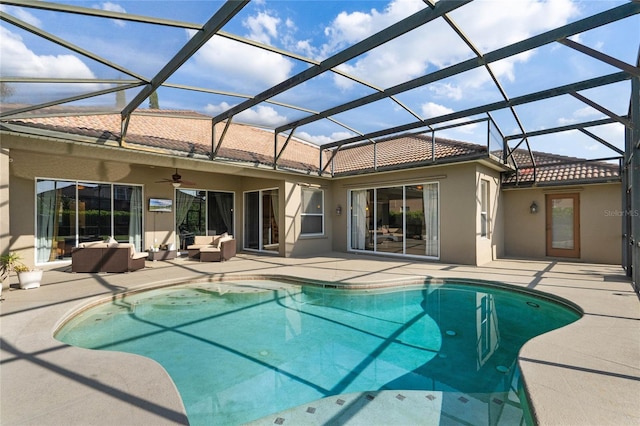 outdoor pool with ceiling fan, glass enclosure, a patio area, and an outdoor hangout area