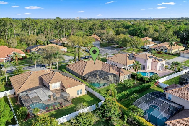 bird's eye view featuring a residential view and a view of trees