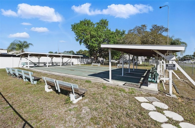 surrounding community with shuffleboard and fence