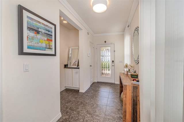 foyer featuring baseboards and ornamental molding