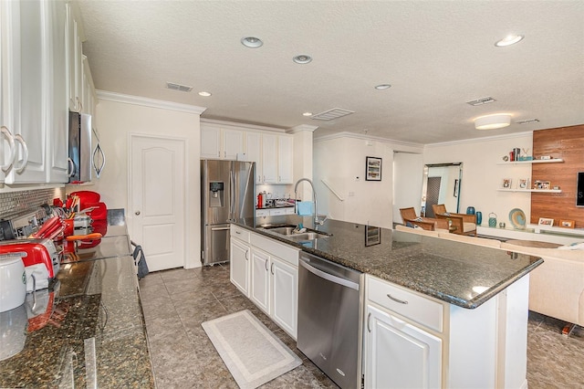 kitchen featuring a sink, white cabinets, visible vents, and stainless steel appliances