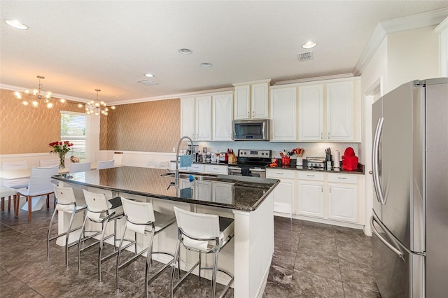 kitchen with a notable chandelier, a sink, stainless steel appliances, white cabinets, and crown molding