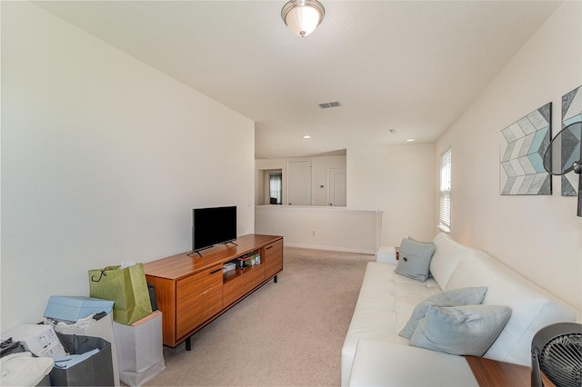 living area featuring light colored carpet and visible vents