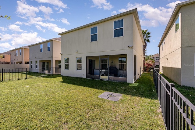 rear view of property with a lawn and a fenced backyard