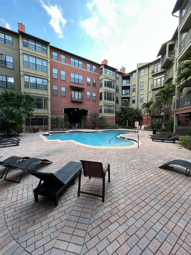 community pool with a patio area