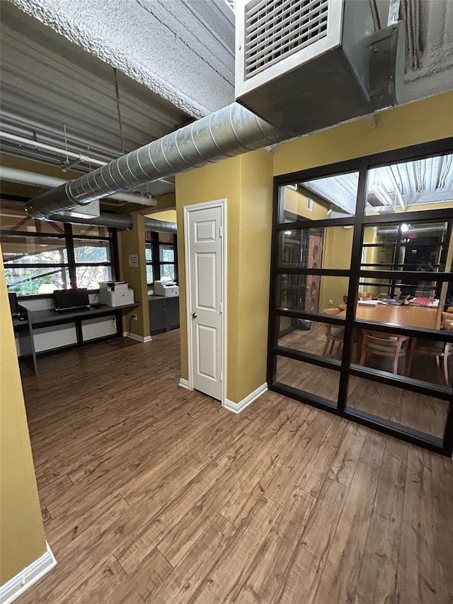 interior space featuring wood finished floors and baseboards