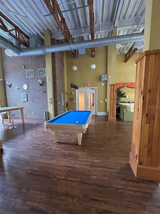 playroom featuring wood finished floors, baseboards, wallpapered walls, pool table, and a towering ceiling