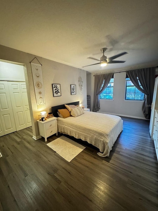 bedroom featuring baseboards, ceiling fan, and dark wood-style flooring