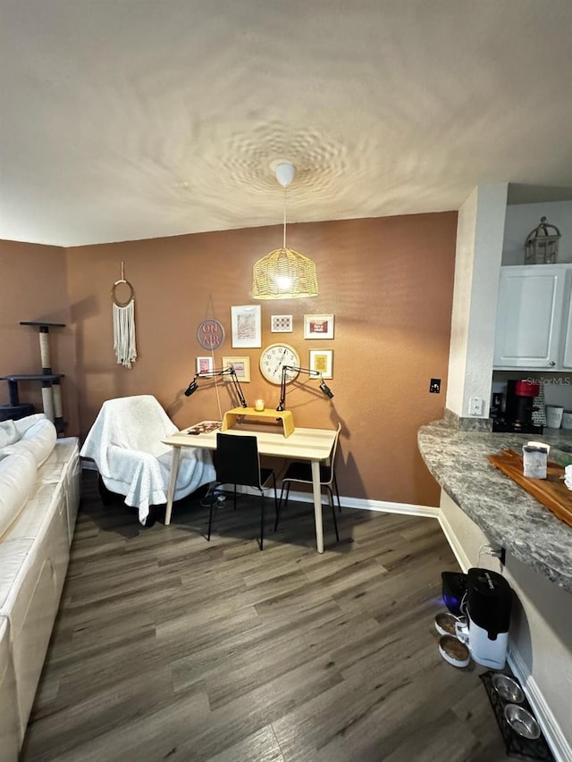 dining area with baseboards and dark wood-style floors