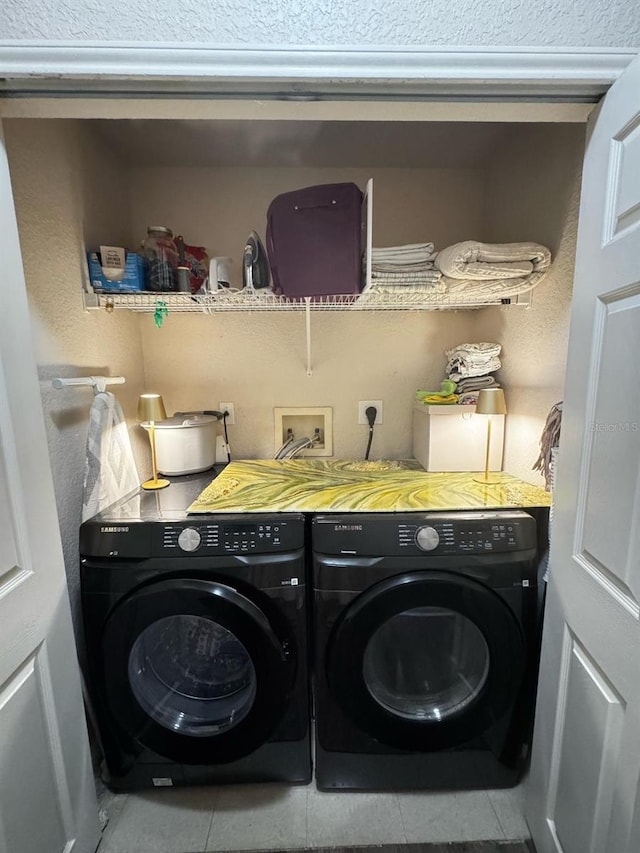 laundry room with washer and dryer, laundry area, and tile patterned flooring