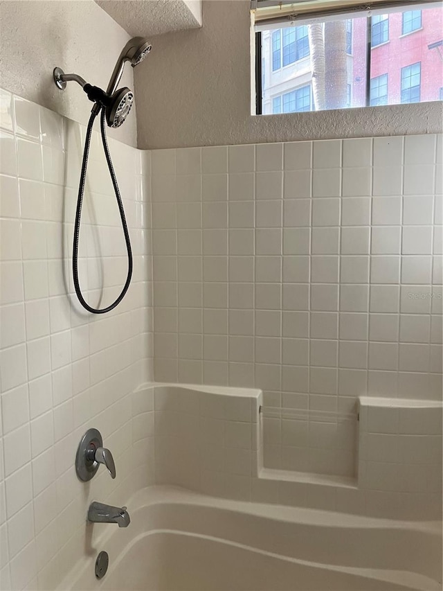 911 N Orange Ave Unit 142, Orlando, FL 32801 - bathroom with shower / washtub combination and a textured wall