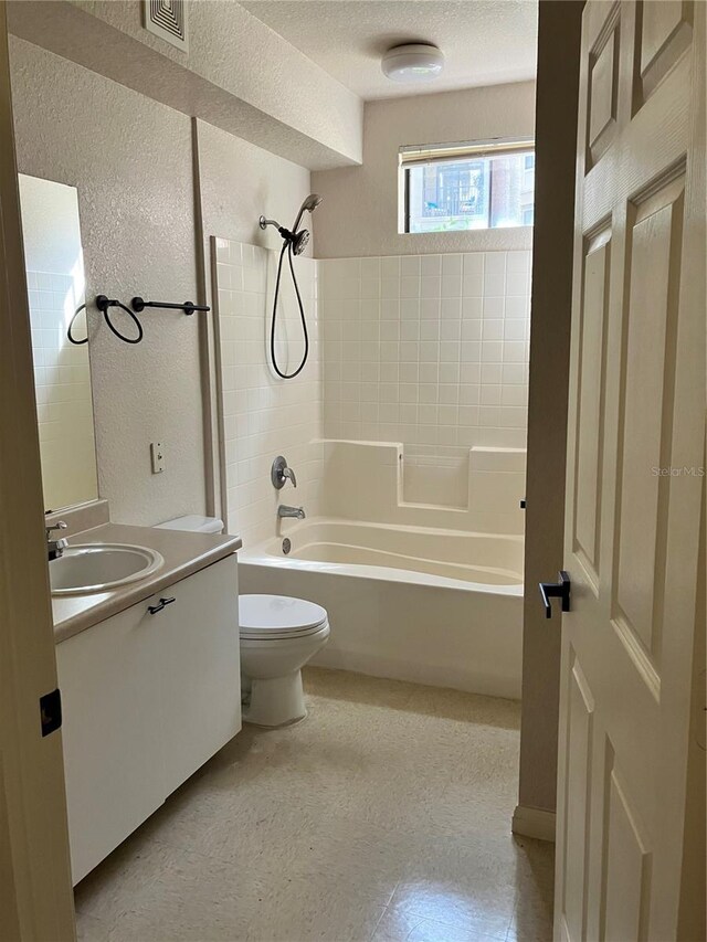 911 N Orange Ave Unit 142, Orlando, FL 32801 - bathroom with a textured wall, toilet, shower / tub combination, vanity, and a textured ceiling