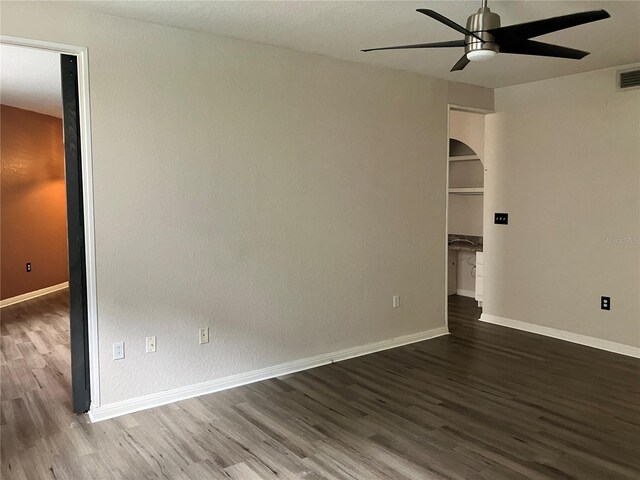 911 N Orange Ave Unit 142, Orlando, FL 32801 - unfurnished room with wood finished floors, ceiling fan, arched walkways, and baseboards