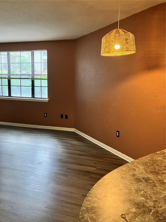 911 N Orange Ave Unit 142, Orlando, FL 32801 - unfurnished dining area featuring dark wood-style floors and baseboards