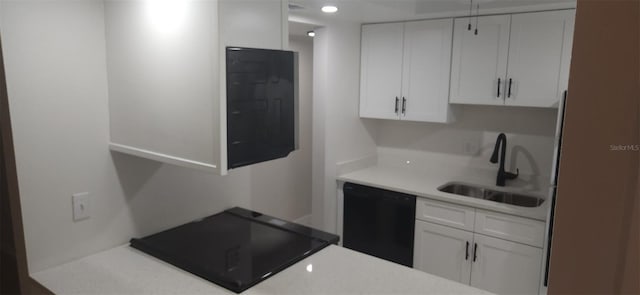 kitchen with white cabinets, dishwasher, light countertops, and a sink