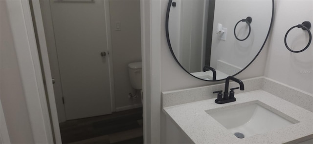 bathroom with toilet and vanity