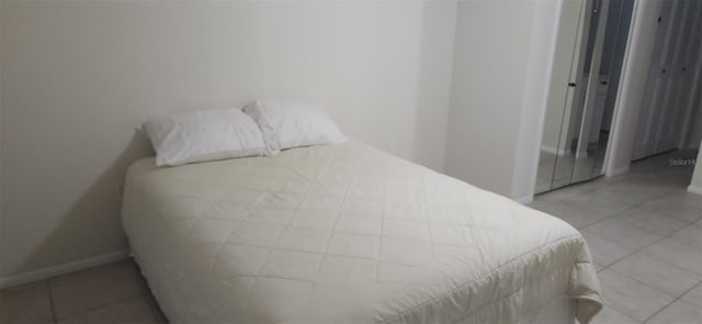 tiled bedroom with baseboards