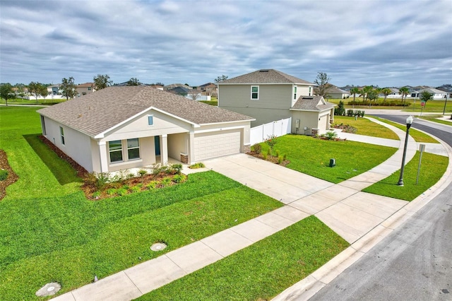 view of front of property with roof with shingles, stucco siding, concrete driveway, a front lawn, and a garage