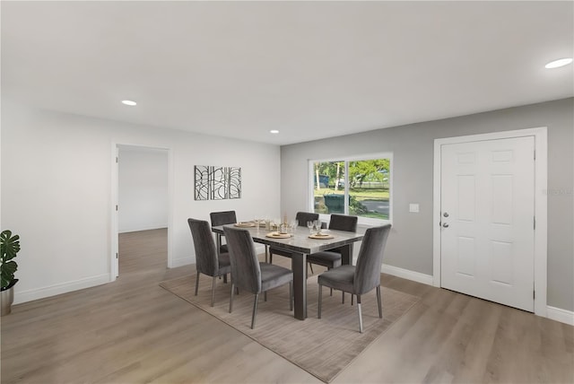 dining space featuring recessed lighting, baseboards, and light wood finished floors