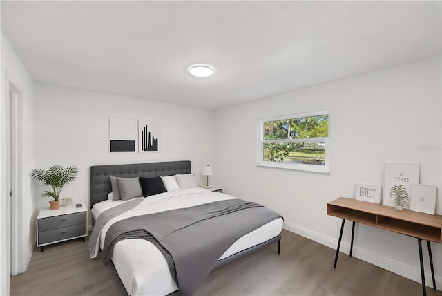 bedroom featuring baseboards and light wood finished floors