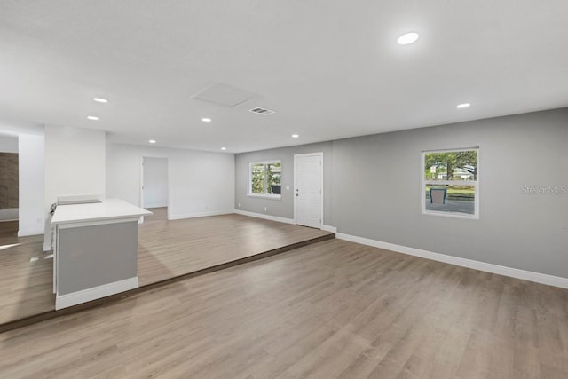 unfurnished room featuring light wood-style flooring, recessed lighting, baseboards, and visible vents