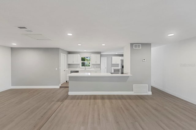 kitchen with visible vents, light countertops, and white cabinetry