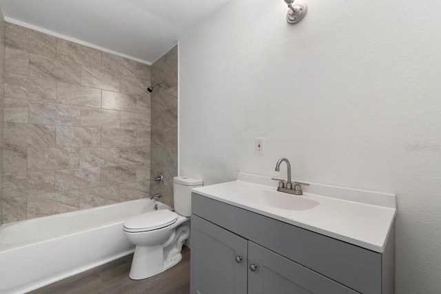 bathroom featuring toilet, wood finished floors, vanity, and shower / tub combination