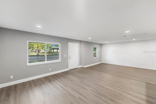 unfurnished room with recessed lighting, baseboards, and wood finished floors