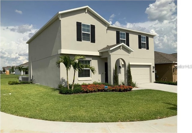 traditional-style house with central AC, stucco siding, a front lawn, concrete driveway, and a garage